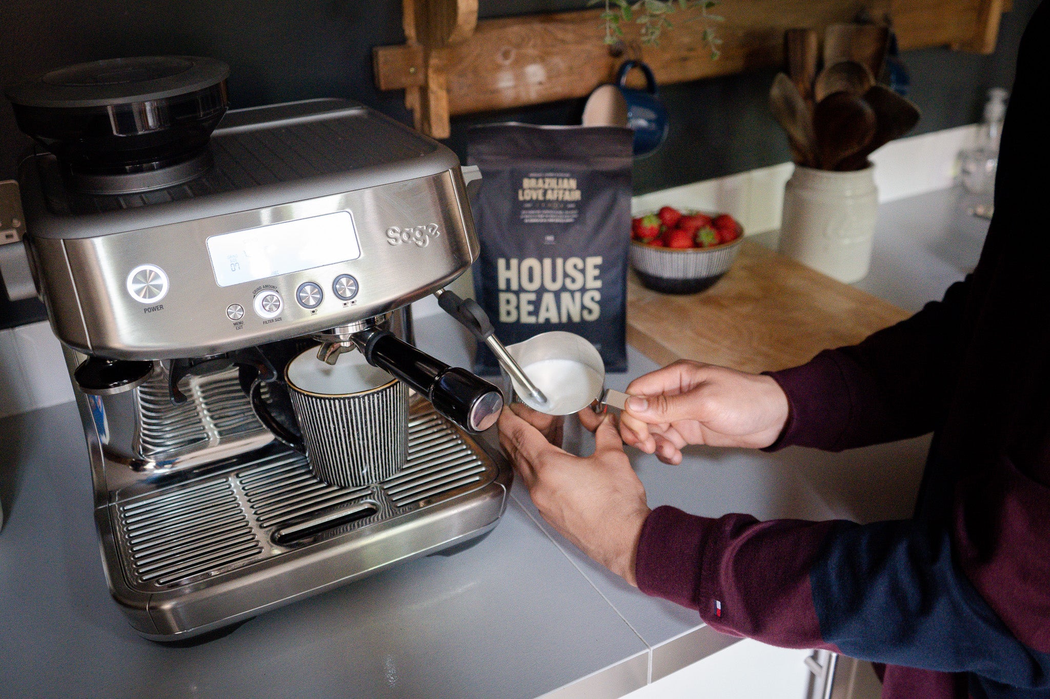 200 degrees coffee beans being poured into a grinder