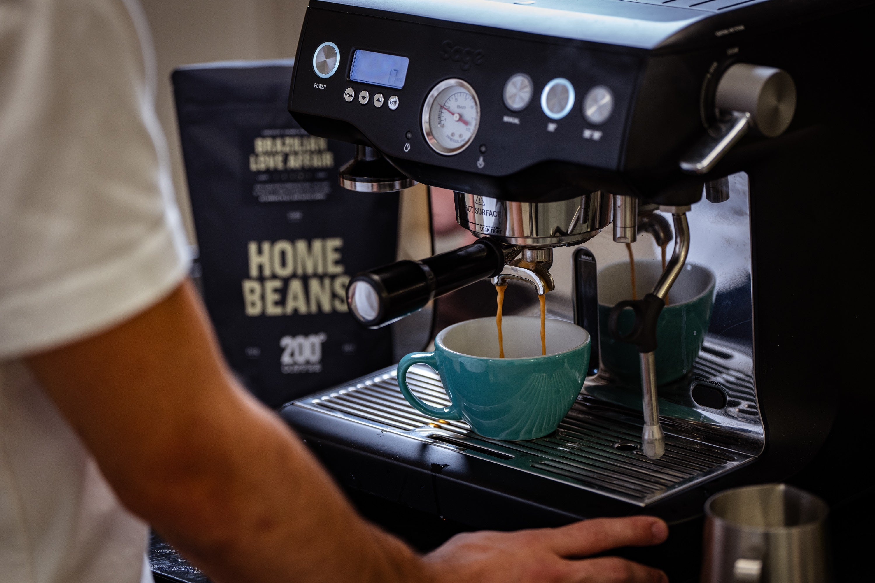 someone making pulling an espresso shot from a Sage Barista Pro