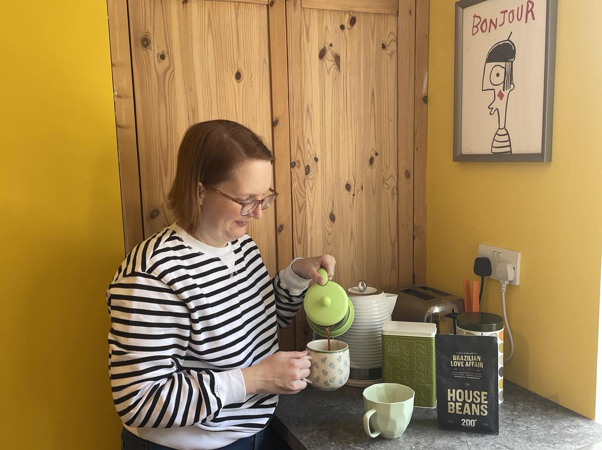 Sinead, our communications manager drinking coffee beans with a cafetiere