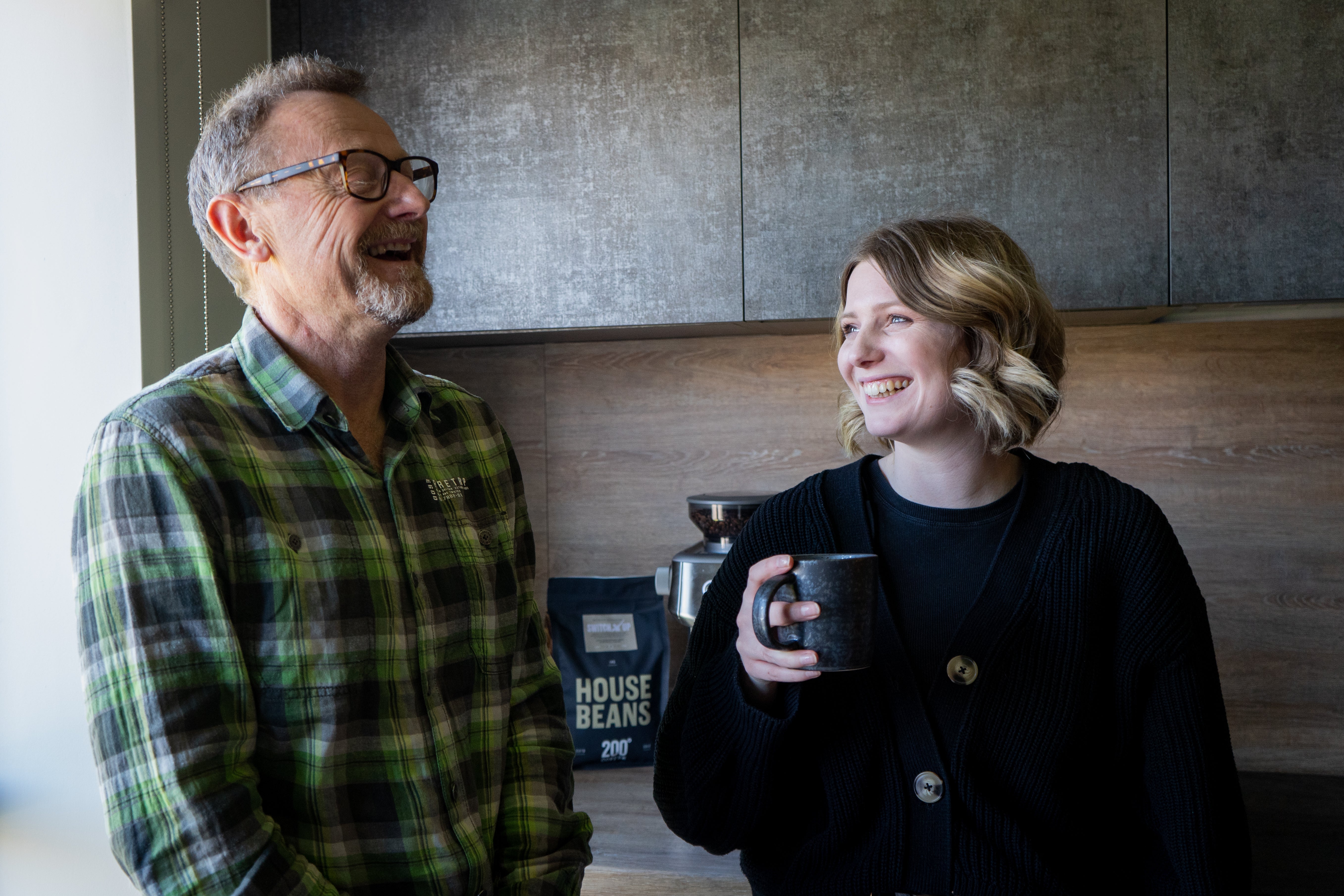 Father and daughter happily enjoying 200 degrees coffee in the kitchen