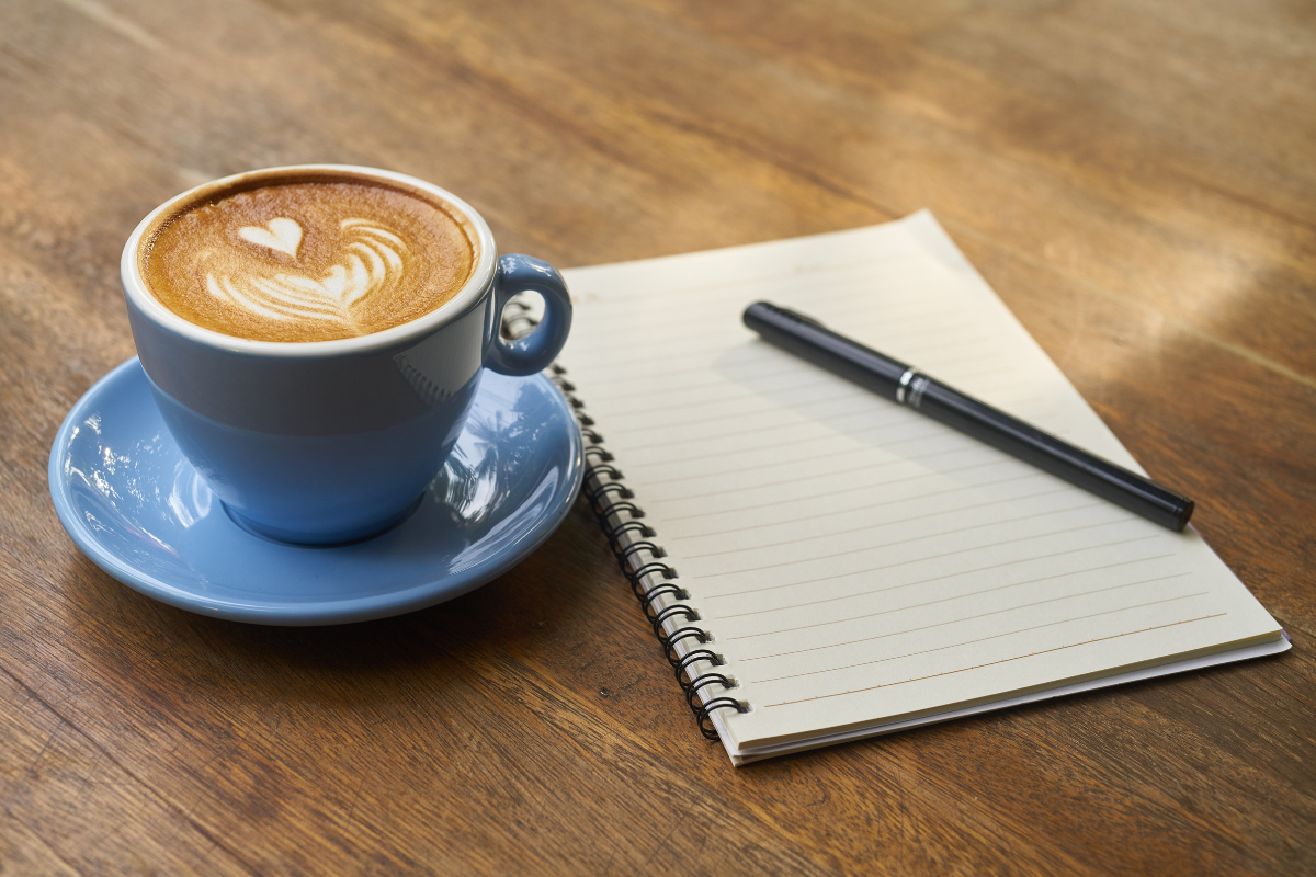 coffee cup and pen and paper the essentials for learning about coffee