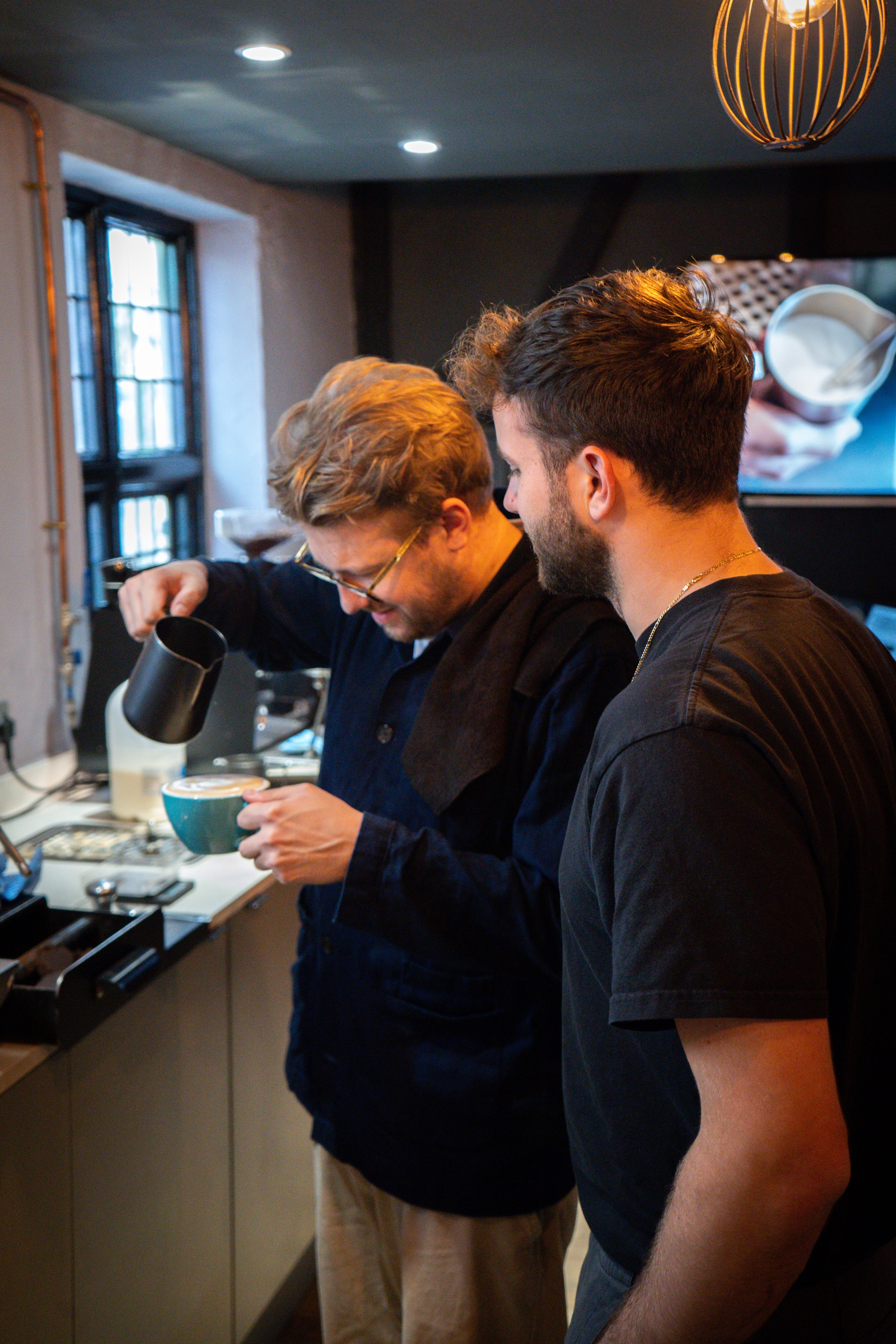 Student being taught to do latte art in Beginner Barista Course