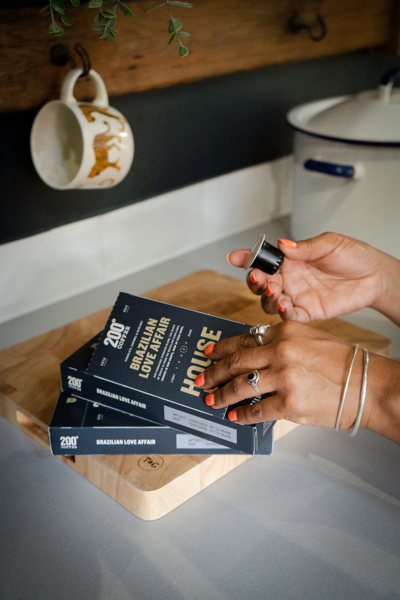 Someone getting a pod out of a Brazilian Love Affair Coffee pod box