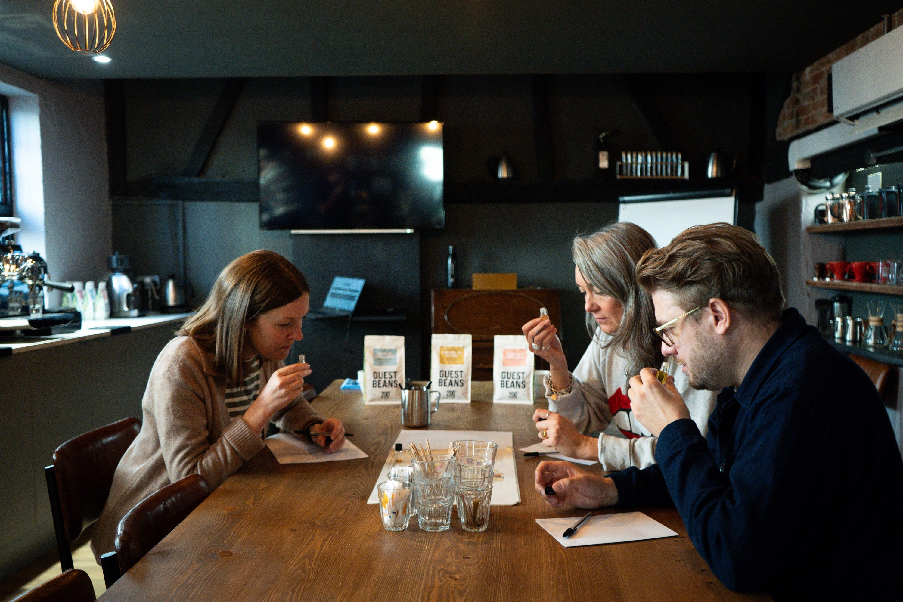 Three students learning about coffee taste notes in 200 Degrees coffee fundamentals class