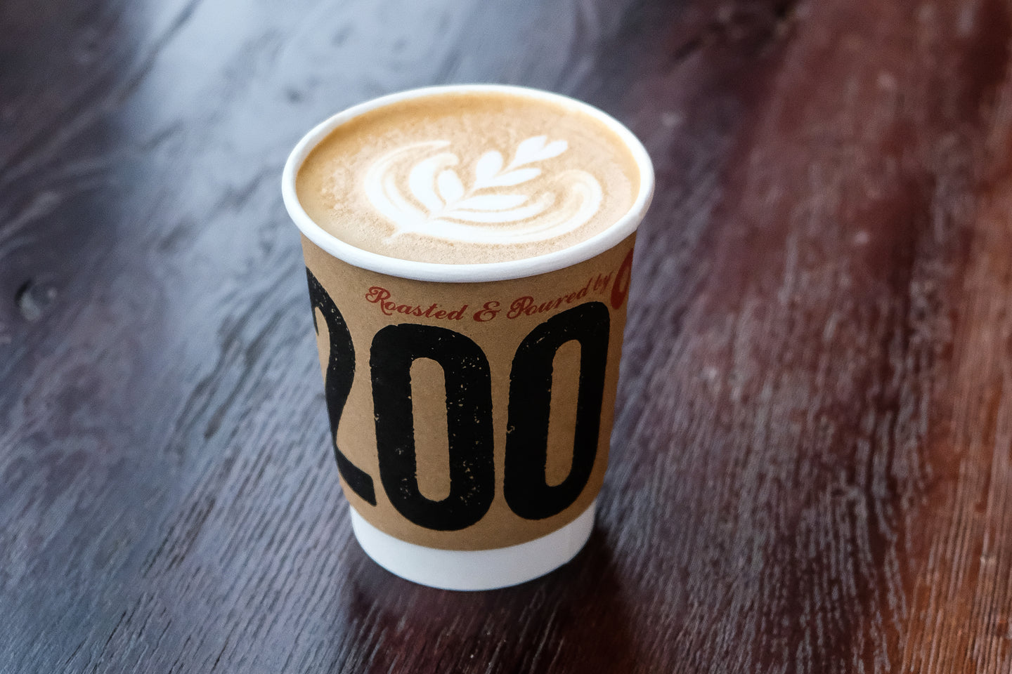 frothy 200 degrees coffee in takeaway cup